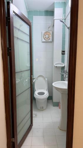 a bathroom with a toilet and a sink at Middle East Building in Salalah