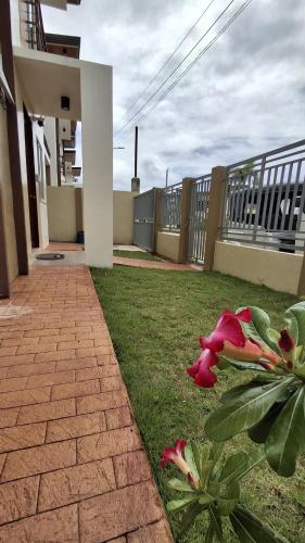 a yard with a brick walkway next to a house at Vacation Home near Panglao Airport and White Sand Beaches in Biking