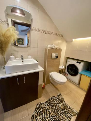 a bathroom with a sink and a washing machine at Villa Moné in Koskinou