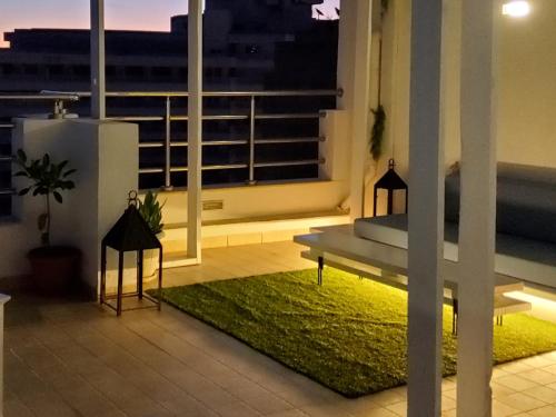 a balcony with a bench and a green rug at Seven Sky Penthouse in Sousse
