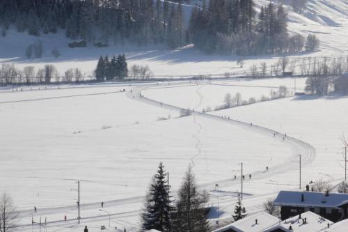 a snow covered ski slope with people skiing on it at Chalet Chinegga in Stalden