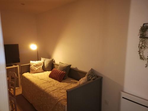 une chambre avec un lit avec deux oreillers dessus dans l'établissement Studio dans maison indépendante, à Lissieu