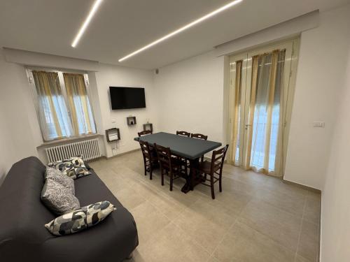 a living room with a table and a black couch at Casa vacanze La Coccinella in Ortona
