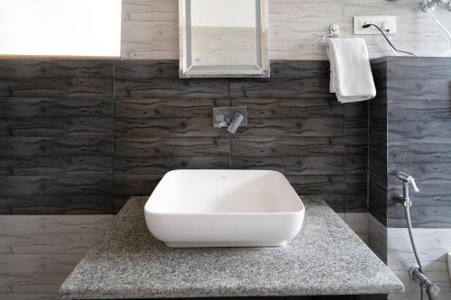a bathroom with a white toilet on a counter at SHUKPA RESIDENCY LoWER TUKCHA in Leh