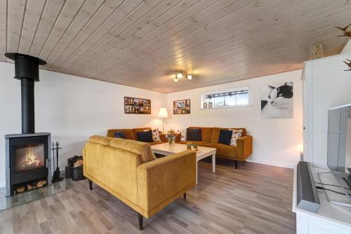 a living room with a couch and a fireplace at Like Home Holiday House 9 B in Varde