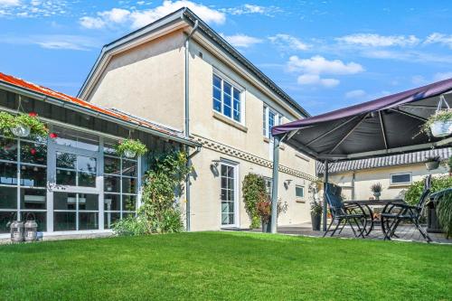 an exterior view of a house with a yard at Like Home Holiday House 9 B in Varde