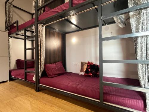 a bedroom with two bunk beds in a room at Green Backpacker's Hostel and Homestay in Amritsar