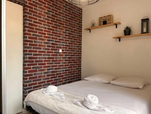 Ένα ή περισσότερα κρεβάτια σε δωμάτιο στο L'Escapade Central - Gare