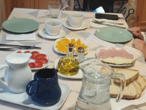 a table with plates of food on it at La Casa Verde in Islallana