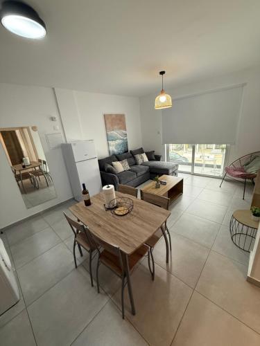 a living room with a table and a couch at WAKE UP BY THE SEA FLATS in Protaras