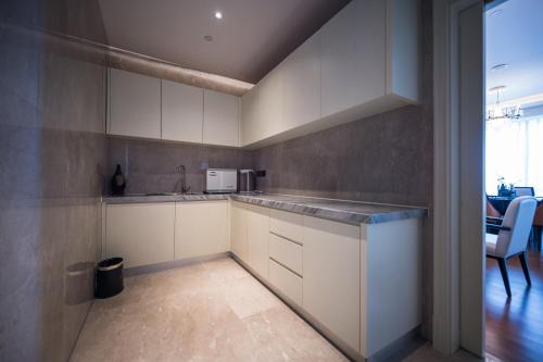 a kitchen with white cabinets and a counter top at Shangrao International Hotel in Shangrao