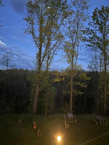 a park with two picnic tables and a light in the grass at Casa del Sindaco in Giusvalla