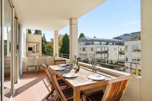 a balcony with a wooden table and chairs at Jenatt Apartments Salamanca in Hobart