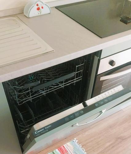 an oven with its door open on a kitchen counter at Pasubio 13 in Selvino