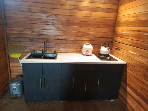 a kitchen with a sink and a counter top at Cabin atas awan in Dieng