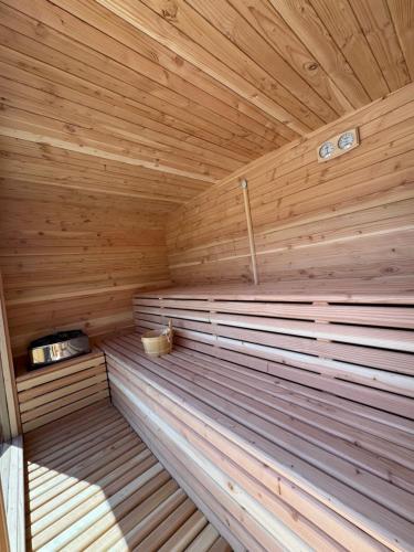 a sauna with wooden walls and a wooden ceiling at Family Hotel Eterno in Tsigov Chark