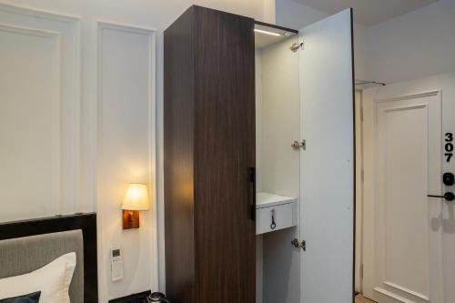a room with a closet with a mirror and a door at Hotel Ichamati in Kolkata
