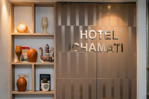 a shelf with vases and a hotelaband sign on it at Hotel Ichamati in Kolkata