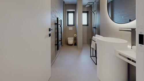 a bathroom with a sink and a toilet at Stay Here Living Apartments in Thiersee