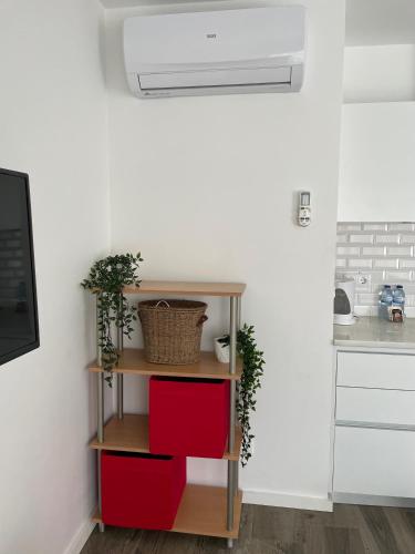 a kitchen with a shelf with red drawers at Botica Guesthouse in Espinho