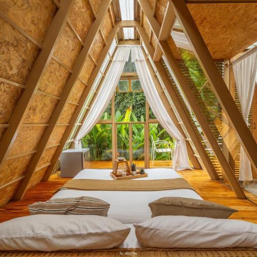 a bedroom with two beds in a attic at บ้านธารหมอก แอท สะปัน in Ban Huai Ti