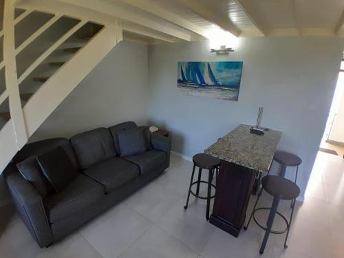 a living room with a couch and a table at Beautiful Beachview 2 Bebroom Loft at Sandcastles in Ocho Rios
