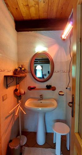 a bathroom with a sink and a mirror at Baita "il Fieniletto" in Bannio