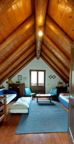 a large room with two beds and a table at Baita "il Fieniletto" in Bannio