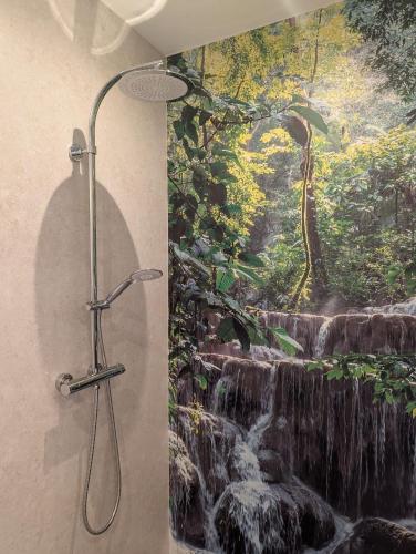 a bathroom with a waterfall mural on the wall at WineDream in Brauneberg
