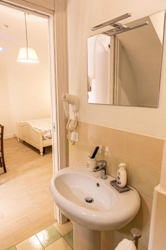 a bathroom with a sink and a mirror at Il Borghetto in Gerace