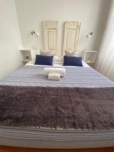 a bedroom with a large bed with two towels on it at Botica Guesthouse in Espinho