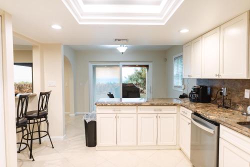 a kitchen with white cabinets and a counter top at Golden Sands Pearl - Florida's Top - ALL Private Beachfront with NEW Pickleball Court, Pool, Spa in Indialantic