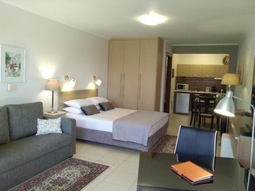 a bedroom with a bed and a living room at Villa Adelais in Tsoukaladhes