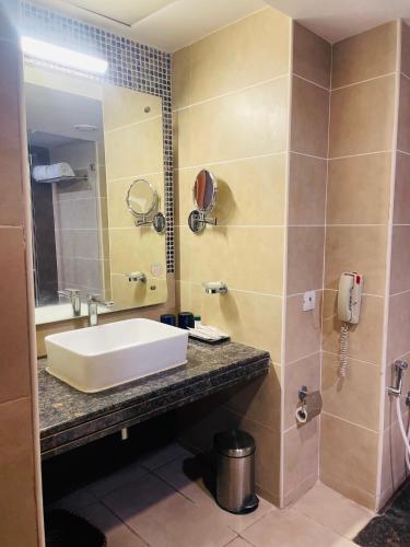 a bathroom with a sink and a mirror at Fortune JP Palace, Mysore - Member ITC Hotels' Group in Mysore