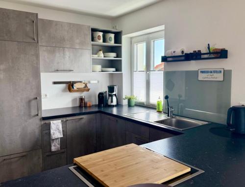 a kitchen with a sink and a counter top at Moderne Ferienwohnung in Prutting