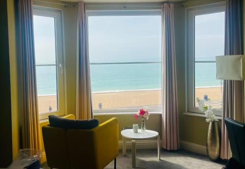 a room with a window with a view of the beach at Stones Throw From The Beach - Stunning Sea View in Portsmouth