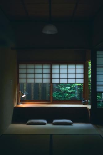 a window in a room with two pillows in front of it at 奈良町宿 紀寺の家 Naramachiyado Kidera no ie in Nara