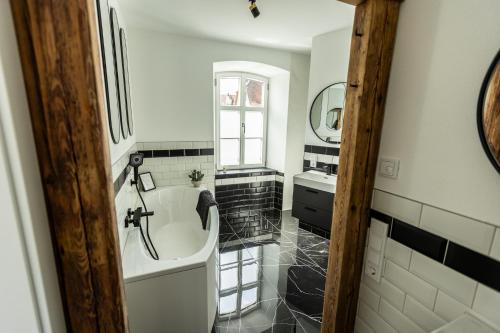 a bathroom with a tub and a sink at Traumzeit Apartments in Dinkelsbühl