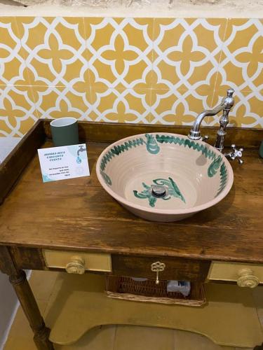 a sink on a wooden table in a bathroom at Alquería de Tajarja in Tajarja