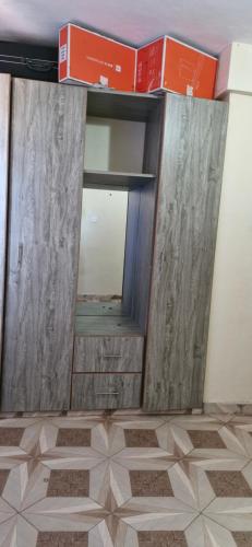a room with two sliding doors and a mirror at GATEWAy in Meru