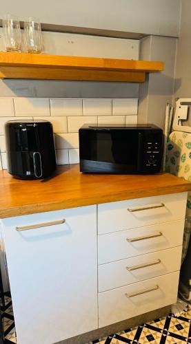 two microwaves sitting on a counter in a kitchen at The Hope in Trowbridge
