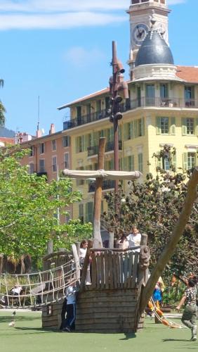 a fountain in front of a building with a clock tower at Family Apartment Old Town near Beach AC in Nice