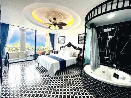 a bedroom with a bed and a bath tub at Nereus Hotel in Con Dao