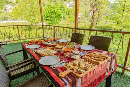a table with food on top of a balcony at Zenilife Suit Apart & Bungalov in Ardeşen