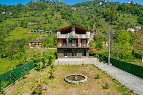 a house on the side of a hill at Zenilife Suit Apart & Bungalov in Ardeşen