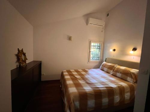 a small bedroom with a bed and a window at Villa La Mer Perazica Do in Budva