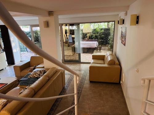 a living room with two couches and a patio at Villa La Mer Perazica Do in Budva