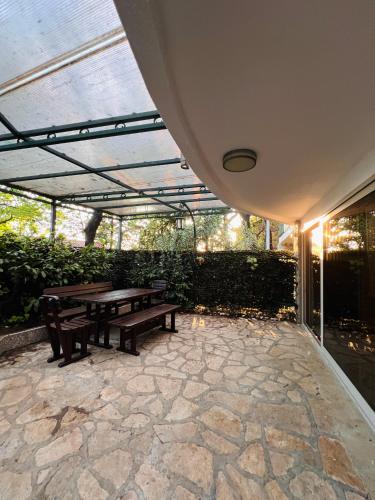 a patio with two benches and a picnic table at Villa La Mer Perazica Do in Budva