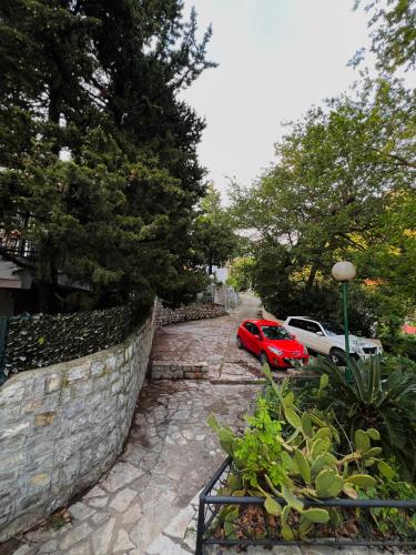 a red car parked next to a stone wall at Villa La Mer Perazica Do in Budva