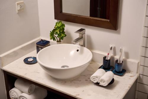 a bathroom with a white sink on a counter at Hoi An Odyssey Hotel & Spa in Hoi An
